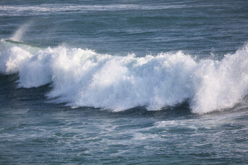 The ocean is rough and the waves are crashing