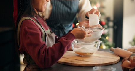 Baking, mother and child with sieve on Christmas for holiday cake recipe, dough preparation or help. Happy family, people and mix ingredients in home for xmas dessert, festive celebration or learning