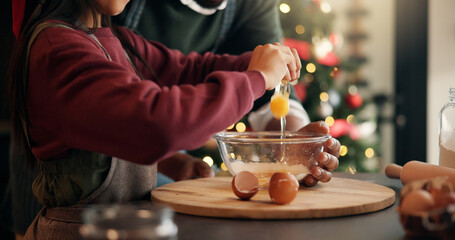 Christmas, eggs and hands of child with parent in kitchen of home for festive tradition or help....