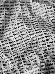 Words Debt Seamless print on crumpled paper for business background.