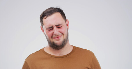 Sad, depression and man in studio with pain for grief, broken heart or disaster on white...