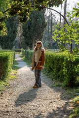 Gardens Woman Italy: Autumnal stroll, scenic park path, casual outdoor portrait.