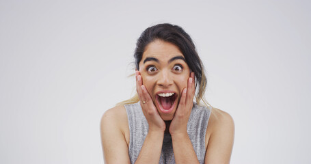 Excited woman, portrait or shock with surprise for good news or alert on a white studio background....