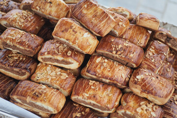 Freshly baked pastries with almond topping on display