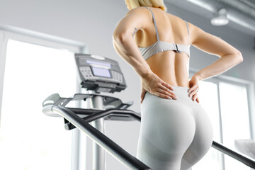 Young woman in sportswear working out at the gym. She is working out on stairway simulator