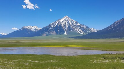 Fototapeta premium A snow-capped mountain majestically rises above a tranquil valley, its slopes contrasting with vibrant green meadows and a calm, shallow lake