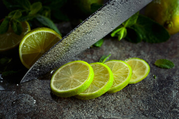 Knife, slices of lime and sprigs of fresh mint.