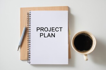 A top view of a blank project plan notebook with a pen and a cup of coffee on a wooden board