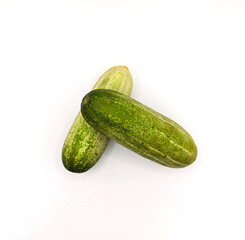 Fresh Organic Cucumbers Isolated on White Background. Group of Green Cucumbers on Clean White Surface. Healthy Green Cucumbers for Diet and Nutrition Design. Top View high resolution image.