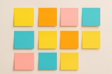 Fototapeta premium Bright sticky notes in neat grid on beige wall representing planning organization creative reminders and productivity visuals
