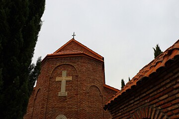 Red brick chapel surrounded by trees