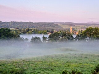 Misty Sunrise Over Countryside Village