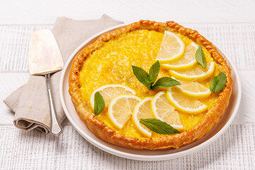 Delicious lemon tart with golden crust and smooth, glossy lemon filling