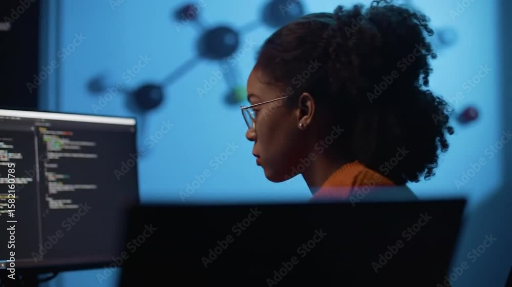 Poster focused young woman coding on computer with blue background and molecular model in science lab with 