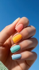 Colorful Pastel Manicure Against Blue Sky