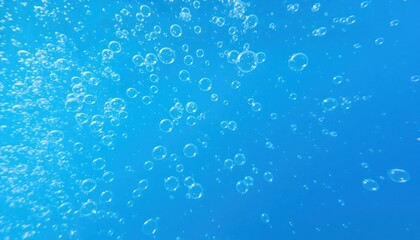 Bubbles floating in a clear blue liquid or ocean, underwater or background.