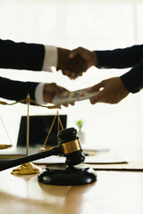 Close-up of lawyer giving legal advice showing professional handshake which is a symbol of fairness, agreement, trust and successful negotiation between lawyer and client in business or court.