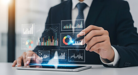 A person in a suit engages with dynamic virtual data displays emanating from a tablet device.