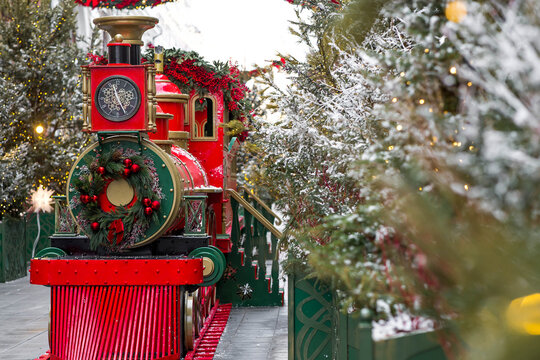 Atmospheric Christmas background. Christmas train on the street in Moscow. New Year's card 2026. Concept of preparing decorations and outfits for the New Year.