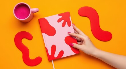 Hand reaching for colorful notebook on bright orange background - Concept of dopamine design  