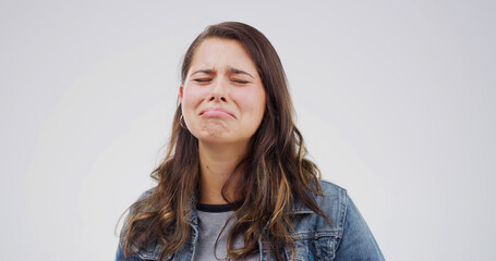 Sad, crying and woman with stress in studio for broken heart, depression or fail on white...