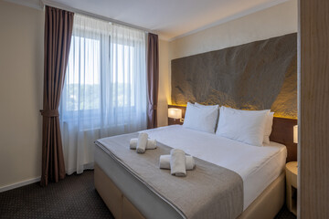 Interior of a hotel room with a master bed in the morning