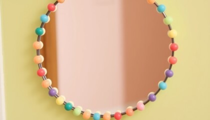 Obraz premium Colorful beaded mirror with a round design in a soft, neutral setting
