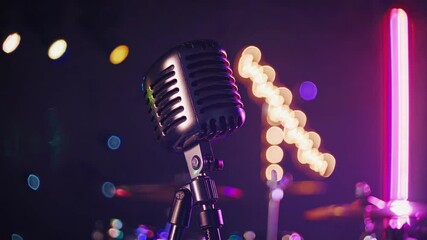 A vintage microphone is positioned center stage, surrounded by vibrant lights and blurred backgrounds. The atmosphere creates anticipation for an exciting music event. Jazz festival, stand up