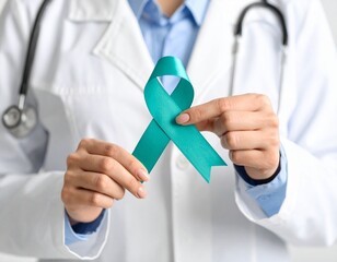 doctor's hand holding teal ribbon support ovarian cancer awareness