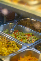 Traditional Indonesian stir-fried bitter melon (pare) with chili peppers, served in a stainless...
