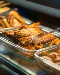 Indonesian-style spiced fried chicken served in a food display warmer, commonly found at traditional restaurants or food stalls in Indonesia.