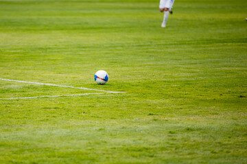 Obraz premium Ball on the grass of a football stadium
