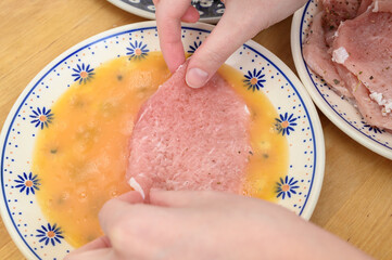 Dip the pork chop in egg and breadcrumbs