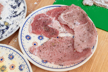 Thin cutlets of lean pork, Wiener schnitzel in the making