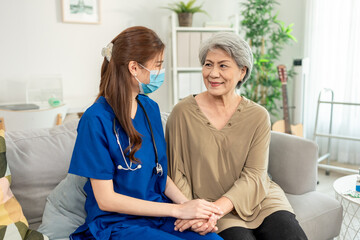 Asian beautiful caregiver examine senior woman patient at nursing home.