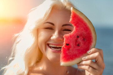 Woman Watermelon Summer Beach: Happy blonde enjoys juicy watermelon slice near ocean during sunny...
