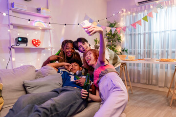 Group of diverse Generation Z friends taking selfies while party in house.