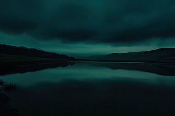 Dark teal lake reflects a moody sky