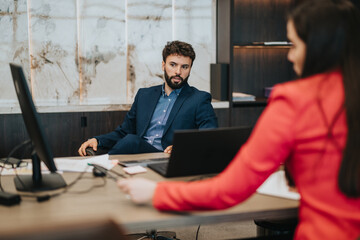 Professional interaction between two business individuals in a modern office setting, showcasing...