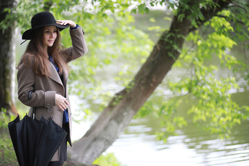 Young girl in a coat in a spring park