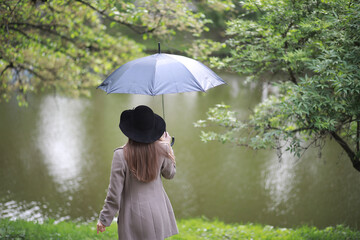 Young girl in a coat in a spring park