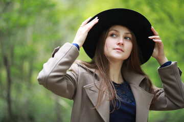 Young girl in a coat in a spring park