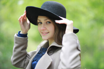 Young girl in a coat in a spring park