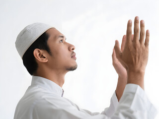 Close up an Asian Muslim man praying side view pose hands open to the sky. Isolated white background