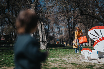 A mother and her baby exploring a scenic park with playful surroundings, emphasizing joy,...