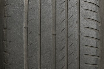 Close-up of a weathered, bald tire showing signs of age
