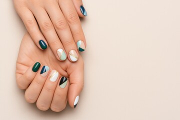 Vibrant nail art on women's hands showcasing trendy colors from a top perspective. Space for caption.