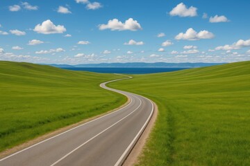 Fototapeta premium A scenic route winding through lush fields with a serene lake backdrop
