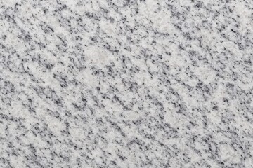 Detailed close-up of a white and gray granite surface with a top-down perspective of marble