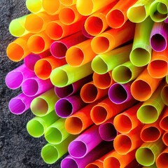Colorful plastic straws densely packed